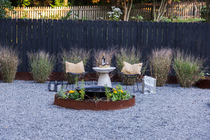 Exceptional gravel garden lines with Edge Right's metal landscape edging. Focus point is a seating area around a small bird bath.